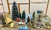 Overall lot showing figurines, trees, packaged items
