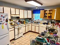 Full kitchen view showing volume of dishware, glassware, utensils and storage items