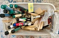 Top view of tote showing rolled fabric tubes, stretcher bars and bag of supplies