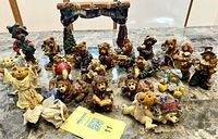 Full group of resin teddy bear figurines on table