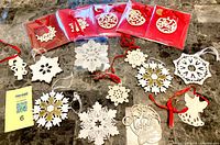 Group shot of all 16 ornaments including five boxed and eleven loose pieces