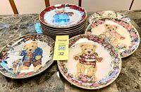 Stack of twelve teddy bear collector plates, three designs visible