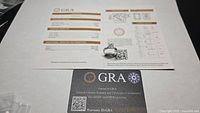 Ring positioned on top of GRA paperwork and warranty card