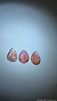 Front view of three leaf-cut pink tourmalines