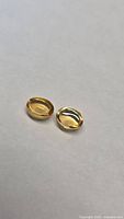Pair of oval cabochon golden citrines on neutral background