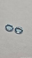 Pair of oval cabochon blue topaz stones on neutral background