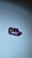 Loose pink-purple octagon spinel on neutral background
