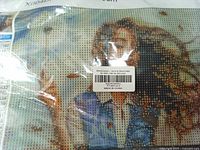 Front view of sealed canvas showing female design and barcode label