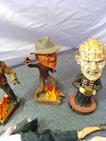 Freddy and Pinhead bobbleheads with bases visible