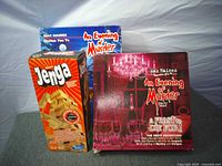 Front view of three boxed games: Jenga, two An Evening of Murder editions