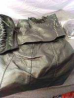 Leather-look skirt with studded corset top, lace-up corset and wig visible