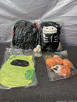 Group shot of six new Halloween plush toys and ghost figurine in original packaging
