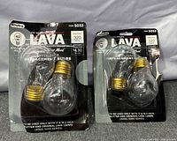 Front view of two sealed Lava bulb packs showing product details and quantity