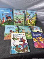 Front covers of all eight Disney Wonderful World of Reading hardcover books