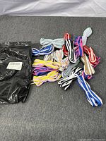 Group of colourful shoelaces and sealed black pack