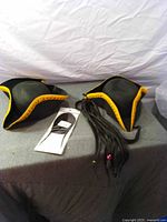 Two tricorn hats, loose braids, packaged braid extension