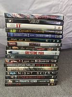 Stack of 16 horror DVD cases showing all spine titles