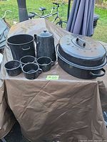 All enamelware pieces grouped together on table