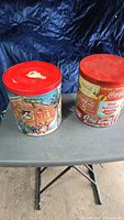 Both tins closed on table showing size and lids