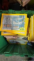 Green tote filled with National Geographic magazines, visible 1950s cover featuring sailboats, note reading #40