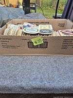 Box filled with stacks of vintage beer coasters