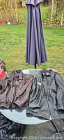 Both leather jackets side by side on table