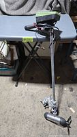 Full view of trolling motor upright showing housing, shaft, clamp, and propeller