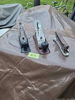 Three items on tarp: two bench planes and stapler