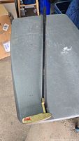 Full view of Coca-Cola putter on table