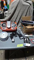Overall lot on table including stereo, lights, CD spindle, adapter cables