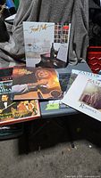 Group shot of five vinyl LP albums on table