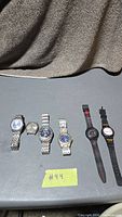 Six watches laid out on table