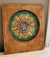 Frontal view of framed heraldic plaque