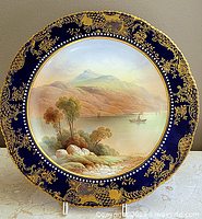 Full view of Aynsley plate showing cobalt and gilt border and landscape center