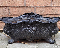 Front view of ornate cast iron planter