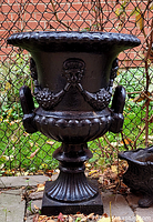 Front view of cast iron urn on pedestal base