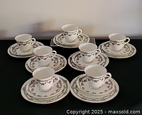 Complete set arranged showing seven cups, saucers and plates