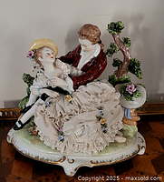 Front view of porcelain courting couple figurine on base