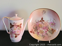 Teapot and bowl front view displaying matching floral design