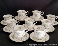 Front view of nine Paragon teacup and saucer sets arranged together