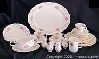 Full lot overview showing platter, bowl, plates, cups, shakers and gravy boat