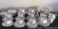 Full layout of cups, saucers, plates, sugar bowl and creamer