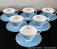 Six cup and saucer sets displayed