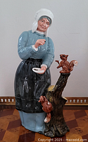 Front view of Royal Doulton Good Friend figurine showing woman feeding squirrels