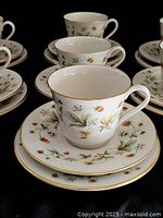 Close-up of one trio highlighting strawberry motif and gold rim