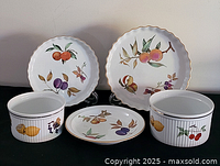 Five Royal Worcester Evesham pieces: two scalloped plates at back, one flat plate centre front, two ribbed casseroles sides