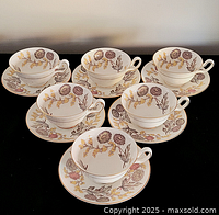 Six Wedgwood cup and saucer sets displayed