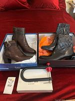 Overview of lot showing two boxed pairs of boots and shoe stretcher
