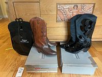 Both pairs of boots atop boxes with two CedarFresh boot care forms