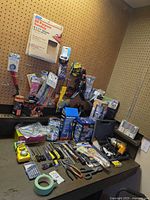 Overall view of all hand tools, boxed power items, and accessories on workbench